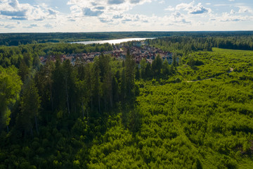 Fototapeta premium Aerial view on the countryside, the village and the lake on the horizon on a summer day