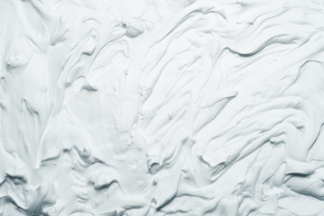 White foam texture abstract art background. Smeared whipped cream design surface.