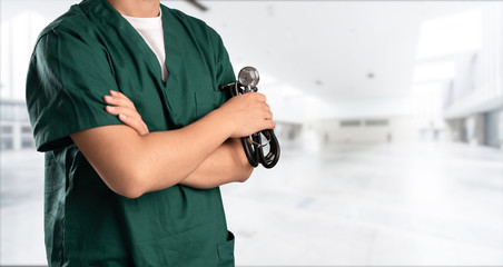 young doctor with hospital background