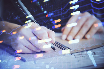 Double exposure of writing hands on background with data solution hologram on front. Technology...