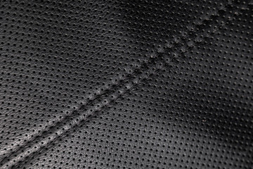 close-up black perforated leather car seat. Skin texture