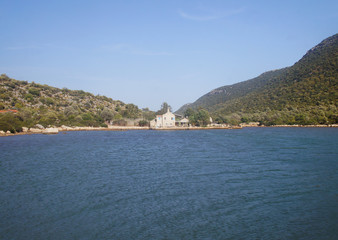 Naklejka premium House on the coast of the sea bay.