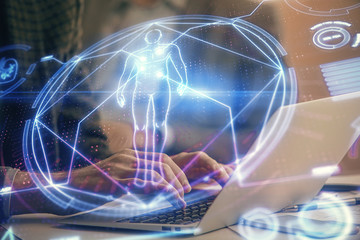 Naklejka na ściany i meble Science hologram with man working on computer on background. Concept of study. Double exposure.