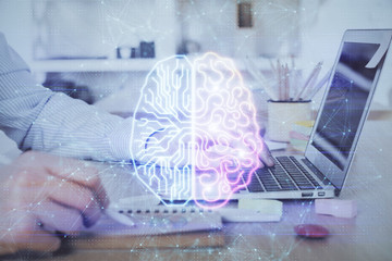 Man typing on keyboard background with brain hologram. Concept of big Data. Double exposure.