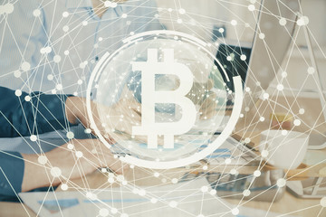 Crypto currency theme hologram with businessman working on computer on background. Concept of...
