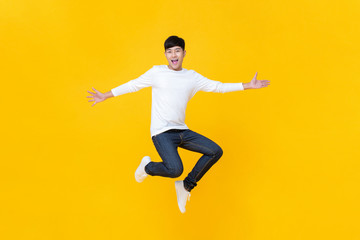Fototapeta na wymiar Young happy Korean teen jumping welcomely