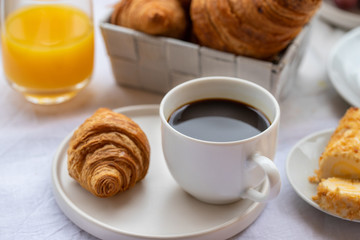 French breakfast, hot cup of coffee with croissants and orange juice. Good morning concept background.