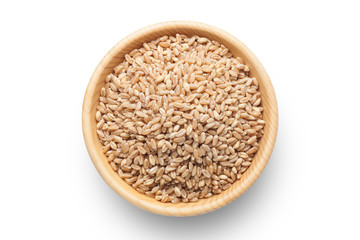 Wheat grains in a wooden bowl isolated on white background.