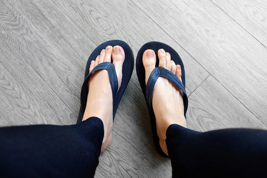 Black Flip Flops Isolated for Fashionable. Close Up of Legs Woman. Top View. Woman Wear Black Footwear, Sandals on Wooden Background