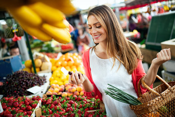 Young woman shopping healthy food on the market