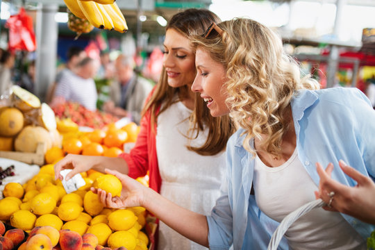 Beautiful happy women shopping vegetables and fruits