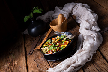 Pasta salad with green asparagus, olives and parma ham