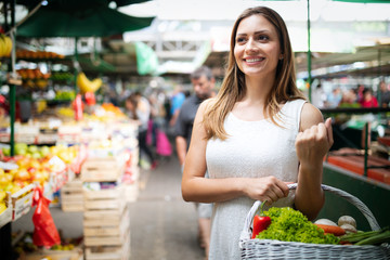 Young woman shopping healthy food on the market