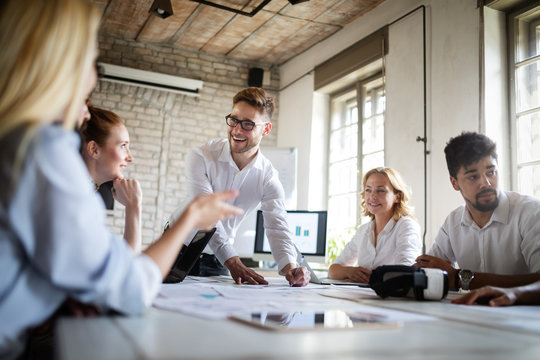 Successful happy group of people learning software engineering and business during presentation