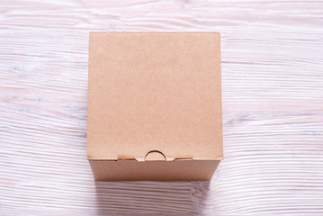 Fototapeta premium Cardboard box on wooden background