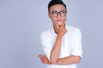 Asian young handsome attractive man with hand showing pointing message on blank background