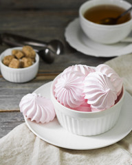 Pink meringue. French dessert. On the grey table