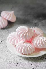 Pink meringue. French dessert. On the grey table