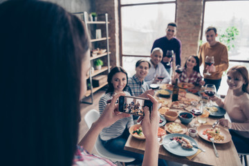 Close up photo friendly company event different race guys raise glasses beverage look camera telephone tradition image sit table shirts formal-wear sweater pullover loft room cafe restaurant indoors