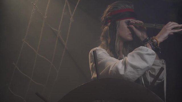 Pirate captain on the ship is looking around through the spyglass, 4k