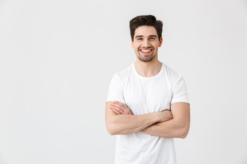 Happy young excited emotional man posing isolated over white wall background.