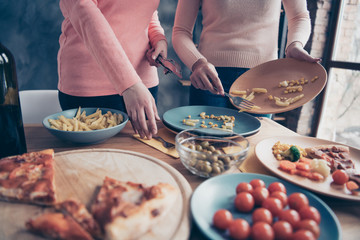 Cropped close up photo two people she her ladies arms hold dirty plates clean wash table holiday...