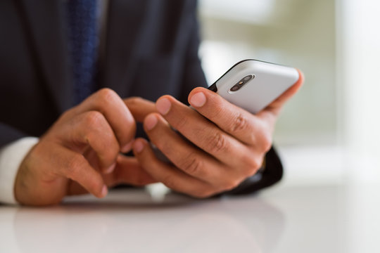 Close up of business man hands using smarpthone