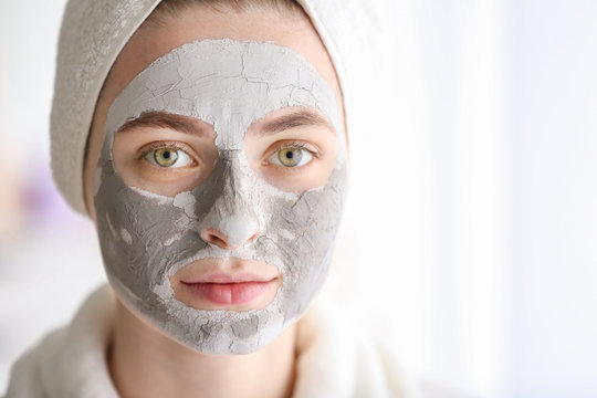 Young Woman With Clay Mask At Home