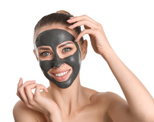 Beautiful young woman with facial mask on white background