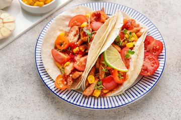 Plate with tasty tacos on grey background