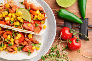 Plate with tasty tacos on table, closeup