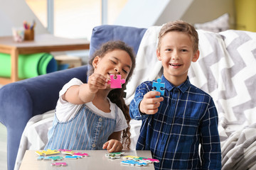 Happy adopted children doing puzzle in their new home