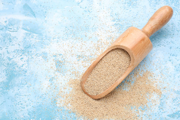 Scoop with white poppy seeds on color background