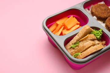 Lunch box with tasty food on color background