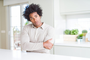 African American man at home skeptic and nervous, disapproving expression on face with crossed...