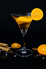 orange cocktail, Christmas hot drink in glass with orange, cinnamon, star anise, Clove.