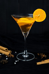 orange cocktail, Christmas hot drink in glass with orange, cinnamon, star anise, Clove.
