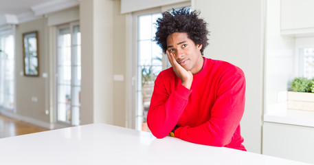 Fototapeta na wymiar African American man wearing casual red sweatshirt thinking looking tired and bored with depression problems with crossed arms.