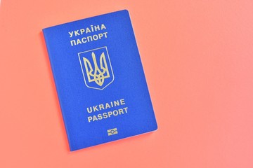 Biomedical Ukraine id passport on orange background with selective focus and empty space for photo or text. Ukrainian id passport with a golden symbol trident on brown backdrop. Copy space 