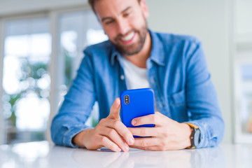 Close up of man hands using smartphone and smiling