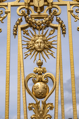 The golden entrance gate of the famous Palace of Versailles. Palace Versailles was a royal chateau. Versailles, Paris, France.