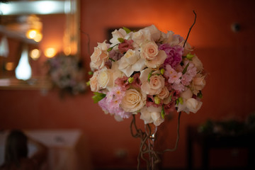 bouquet of flowers on a leg in the interior of the restaurant for the celebration of the flower shop wedding salon