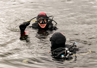 Fototapeta na wymiar scuba diving in a mountain lake, practicing techniques for emergency rescuers. immersion in cold water