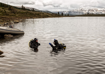 scuba diving in a mountain lake, practicing techniques for emergency rescuers. immersion in cold...