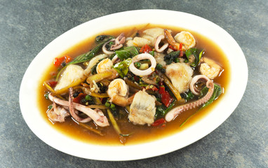 Fried stir spicy sea food on stone background, food concept Top view.