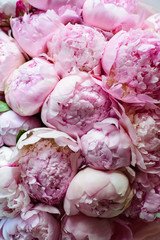 peonies in a bouquet of flowers on a leg in the interior of the restaurant for a celebration shop floristry wedding salon