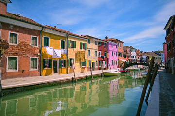 Fototapeta na wymiar Beautiful vibrant colorful houses in Burano with narrow street near Venice in Italy.