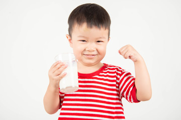 Little Asian boy drinking milk from th glass with happy face