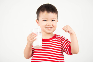 Little Asian boy drinking milk from th glass with happy face