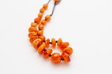 amber beads on white background